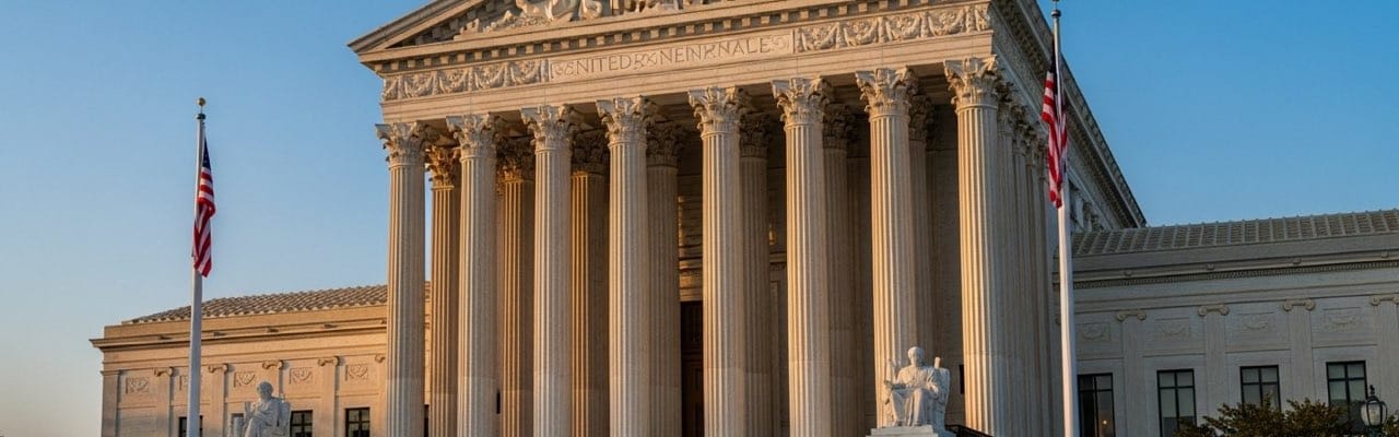 Front facade of the United States Supreme Court building with marble Corinthian columns at golden hour